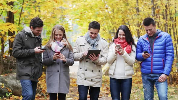 Smiling Friends With Smartphones And Tablet Pc 3 alt