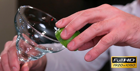 Barman Prepares a Cocktail With Lime and Salt