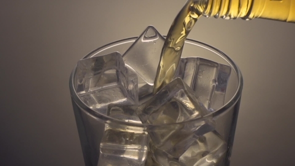Pouring Scotch Whiskey Over Ice