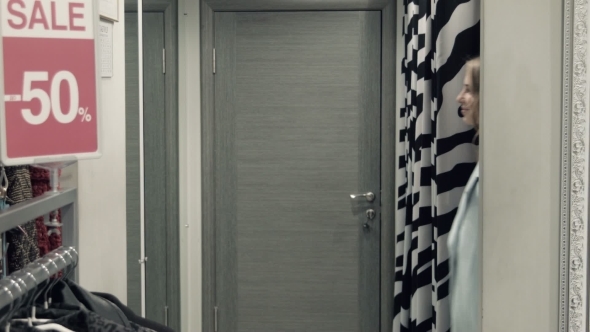 Two Girls Try On a Coat In a Locker Room alt