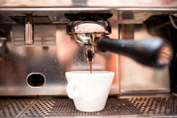 Espresso machine pouring coffee in pub, bar, restaurant