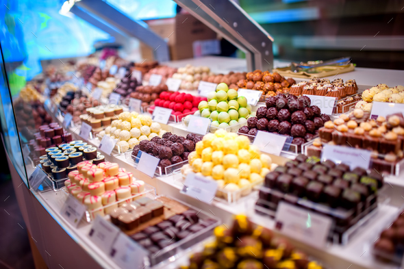 chocolate truffes, candies and sweets store on showcase in factory - Stock Photo - Images