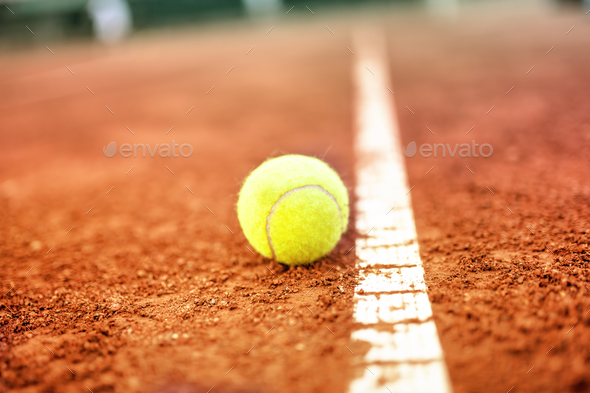 Tennis ball on a tennis clay court - Stock Photo - Images