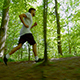 Man In Sportswear Running Through Trees - VideoHive Item for Sale