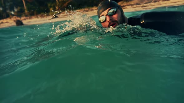 Professional Swimmer Training For Triathlon Competition In Open Water. Swimmer Underwater Workout. alt