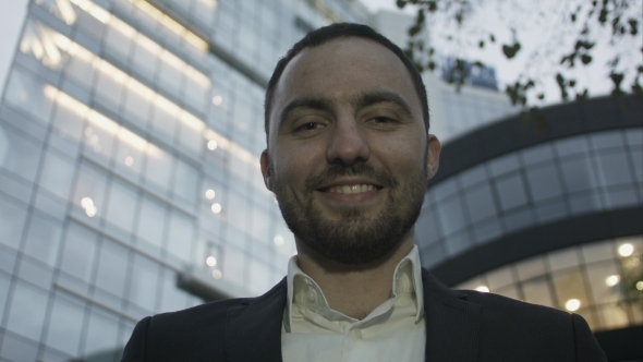 Portrait Of Young Business Man On Office Building alt