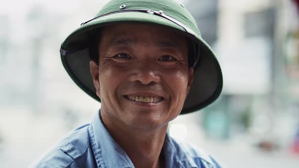 Handheld video shows of Vietnamese mature man looking at camera. Shot with RED helium camera in 8K alt