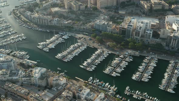 Multiple Yachts and Sailboats Yacht Port on Malta in Beautiful Sunlight, Aerial View alt