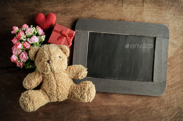blank chalkboard with teddy bear and flowers