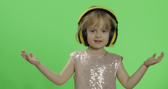 Girl in Glossy Dress and Headphone Listening To Music and Dancing. Chroma Key alt