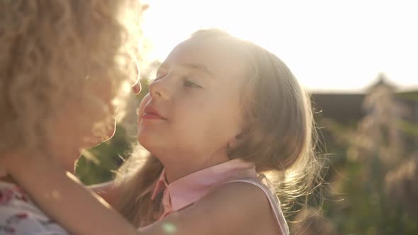 Closeup of Happy Daughter Rubbing Noses with Mother Kissing Parent in Slow Motion alt
