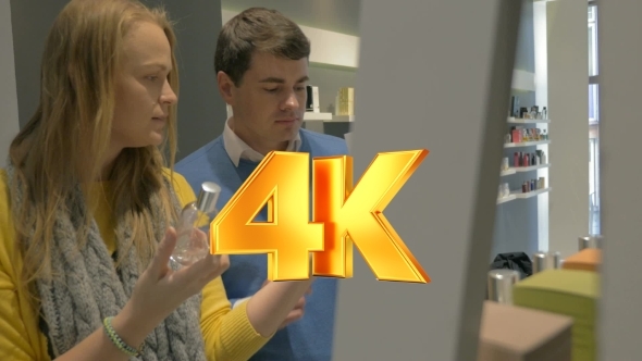 Man And Woman Trying Fragrances In Perfumery Shop alt
