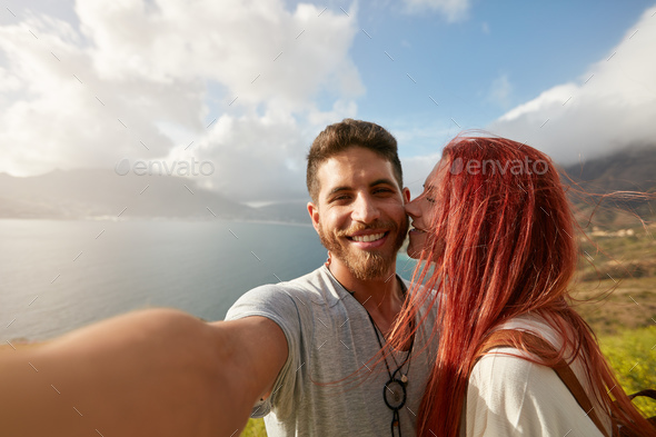 Romantic young couple taking a selfie outdoors - Stock Photo - Images