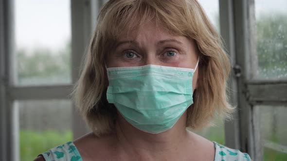 Portrait Of Mature Caucasian Woman In Protective Medical Mask On Self Isolation alt