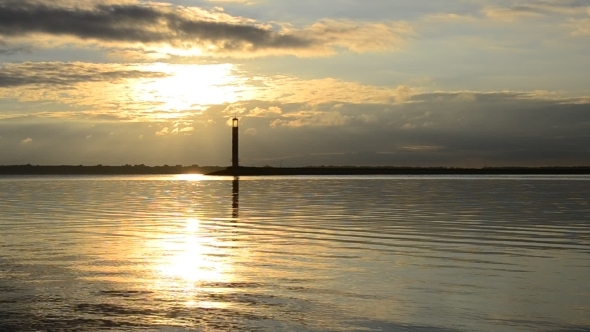 Water Landscape With Lighthouse And Yellow Clouds