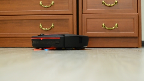 The Robot Vacuum Cleaner Runs In  Room