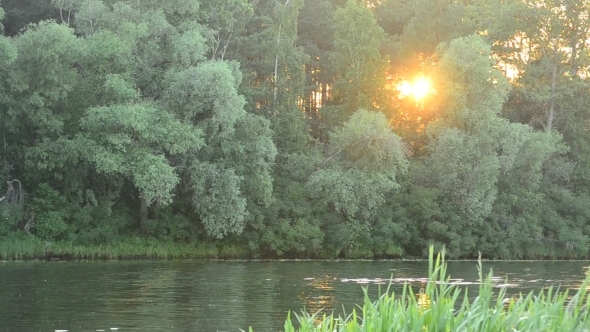 Sunset At River With Sun Light Coming Through