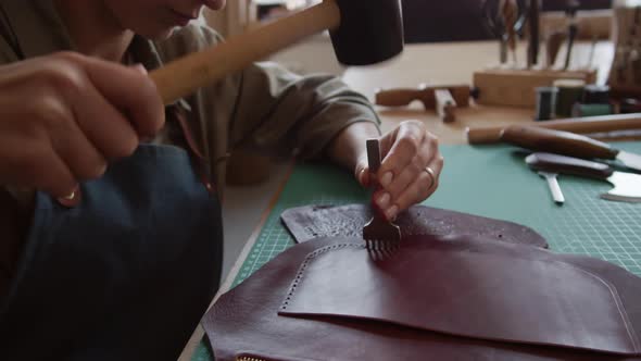 Artisan Making Holes in Leather Bag alt