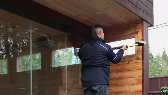 Man Cleaning Walls and Floor with High Pressure Power Washer