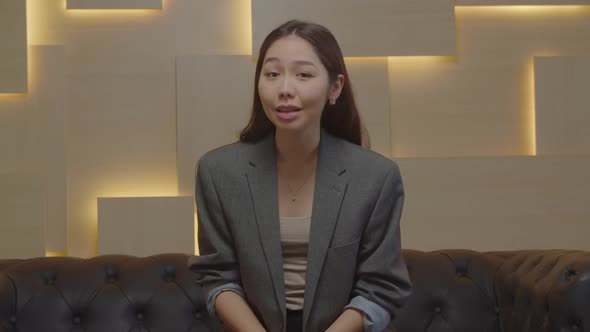 Confident Pretty Asian Woman Talking at Camera During Video Call Indoors alt