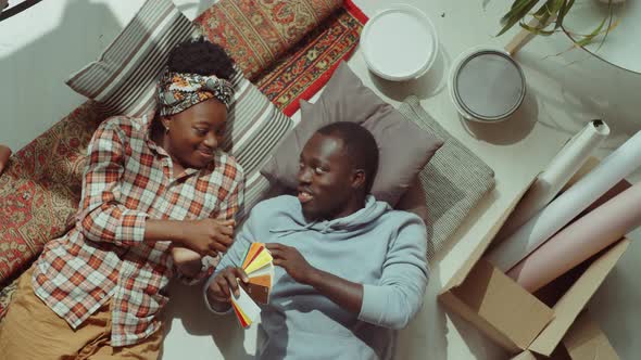 African American Couple Discussing Color Palette during Home Renovation alt