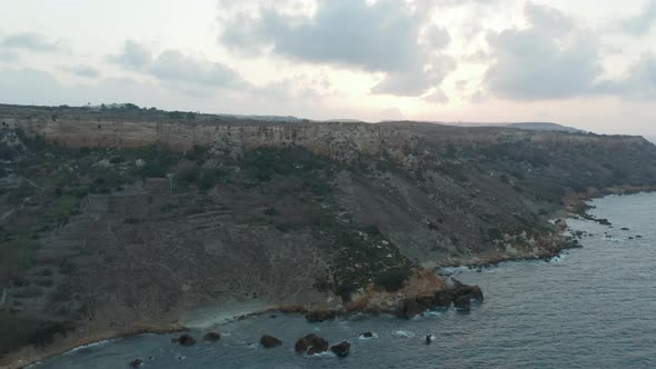 Shoreline of Gozo Malta Island at Sunset, Ocean Waves From Aerial Drone Perspective alt