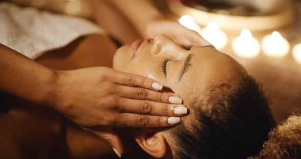 Young Woman Massaging Her Face alt
