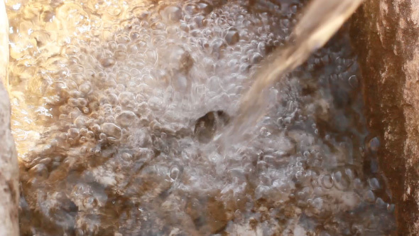 Falling Stream Of Clean Water With Splashing Bubble