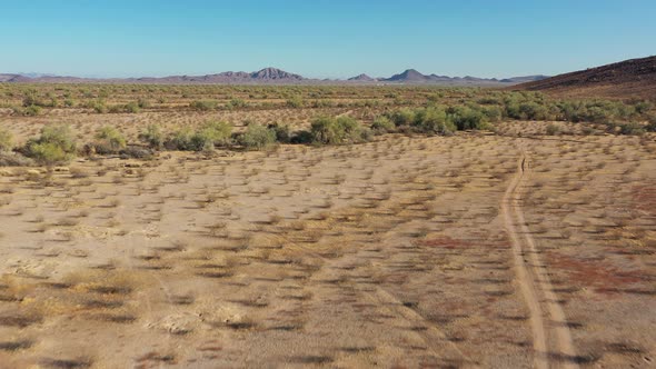 Dirt Road in Southern Arizona Sonoran Desert - Aerial Dolly In Shot alt