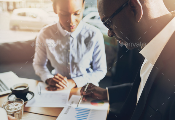 Two black business people discussing their business - Stock Photo - Images