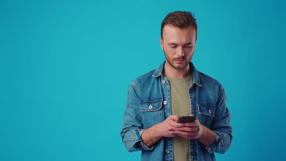 Happy Man Typing Sms on Blue Background