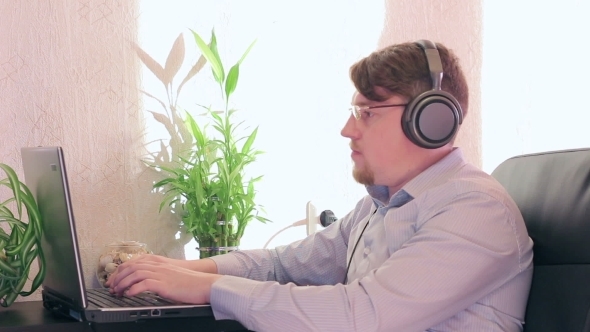 Young Businessman In Glasses And Headphones