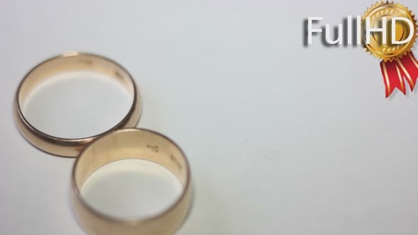 One Wedding Ring Falling on Another