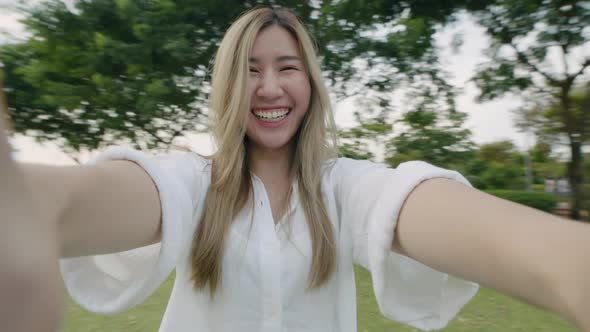 Couple pov girlfriend spinning with boyfriend at a public park.