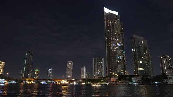 corporate buildings of the metropolis at night on the river bank. business center of a lively city. alt