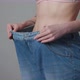 Young Woman Shows her Weight Loss and Wearing Her Old Jeans - VideoHive Item for Sale