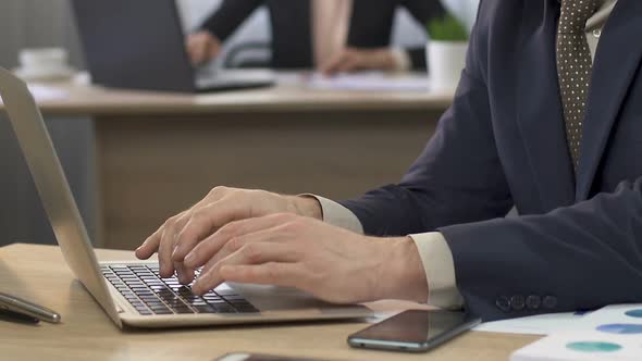 Businessman Opening His Laptop and Answering E-Mail, Business Correspondence alt