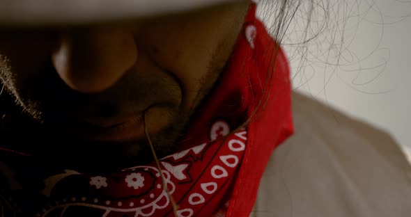 Close up of a handsome wild west gunslinger with a straw in his mouth, 4k alt