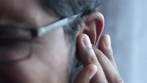 Young Man Having Ear Pain Touching His Painful Ear alt