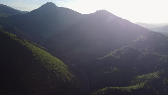 Aerial View of the Valley Below the Mountain Peaks in the Glow of the Setting Sun
