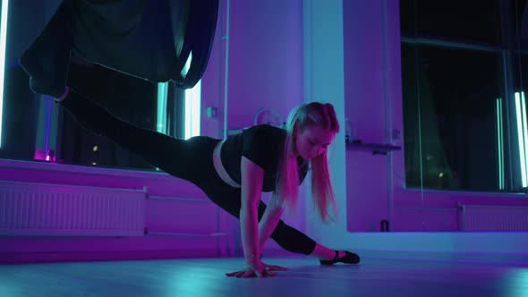 Woman is Stretching Legs Doing Split Position in Yoga Class Using Hammock for Flyyoga alt
