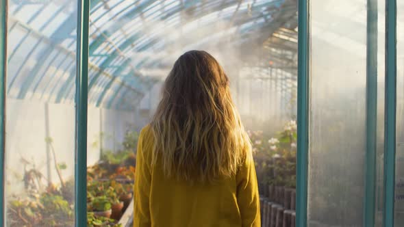 Woman entering a greenhouse