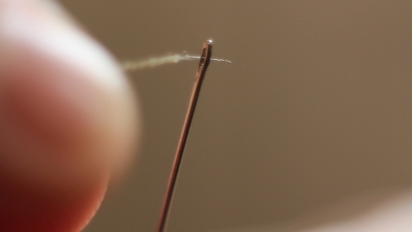 The Woman Inserts the Thread Through the Needle, Stock Footage | VideoHive