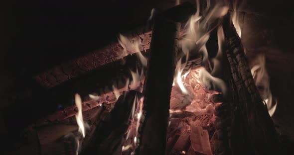 Close Up Footage of the Big Fire with Firewood at Night Brick Walls of the Fireplace Bonfire Burning alt