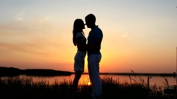 Couple Standing On River Bank  alt