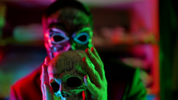 Mystery of Death and Black Magic Man with Skull Mask is Playing with Human Skull Serial Killer alt