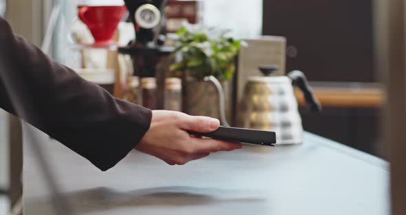 Closeup Woman Paying Using NFC Technology with Phone Contactless Payment with Student Girl Business alt
