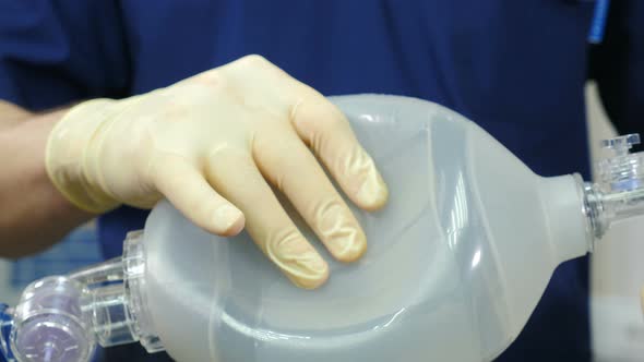 Anesthesiologist with Resuscitation Breathing Bag or Ambu Bag in Hands alt