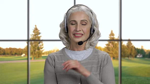 Close Up Mature Call Center Operator in Headset. alt