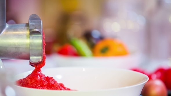 Mincing Machine Grinding Ripe Tomatoes Into Paste